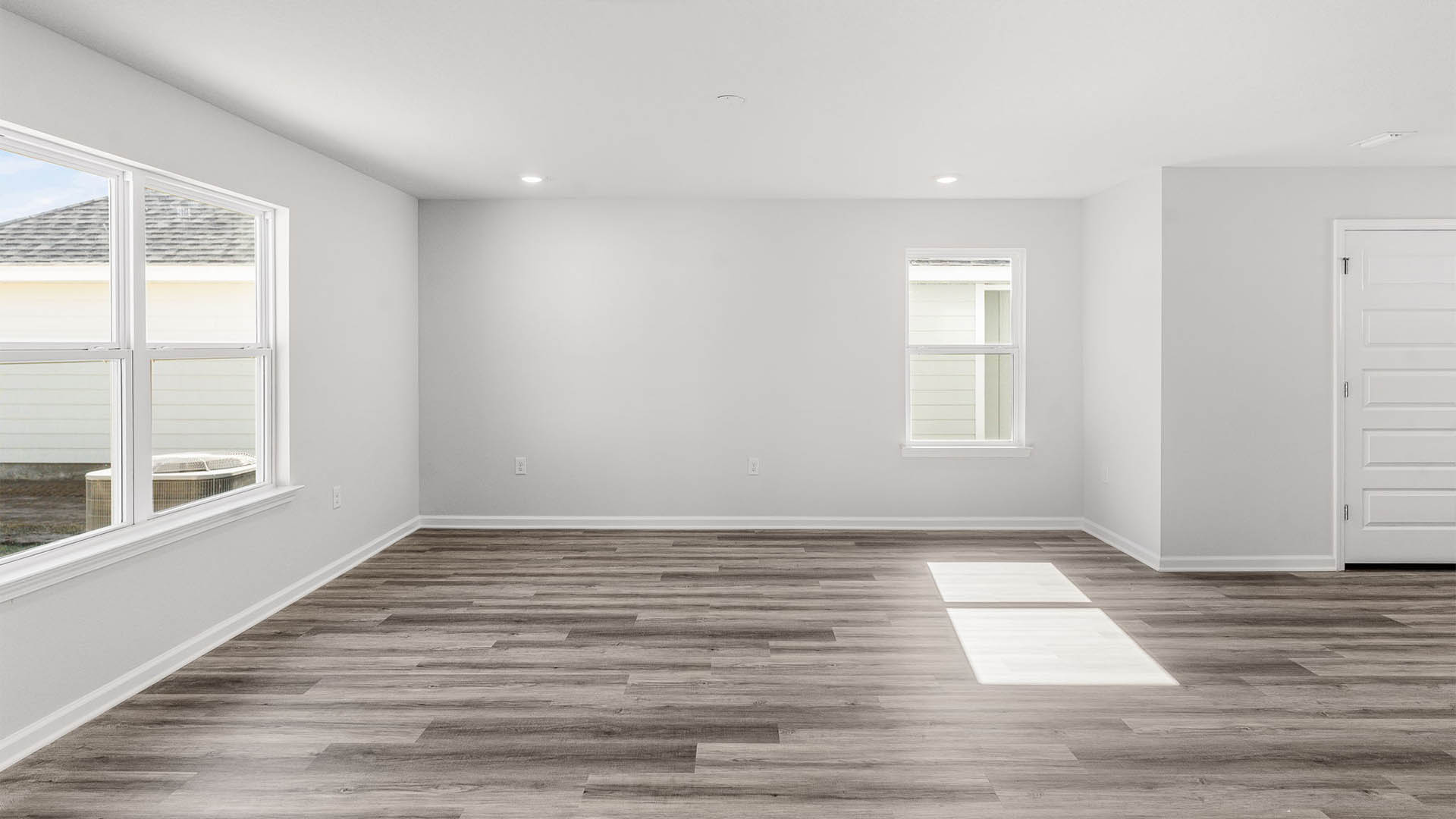 Living room area with EVP flooring and windows.