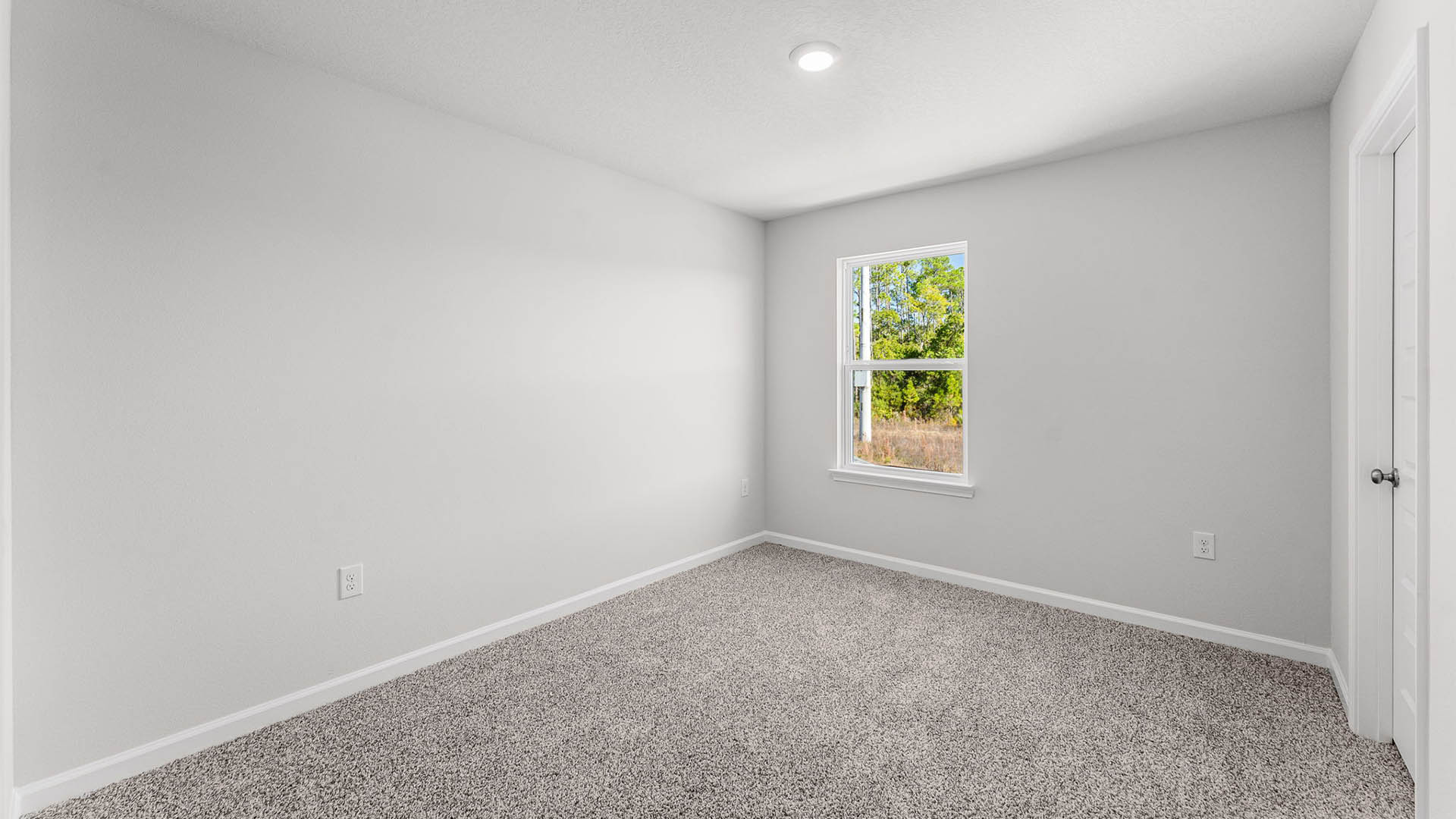 Bedroom with carpet floor and window.