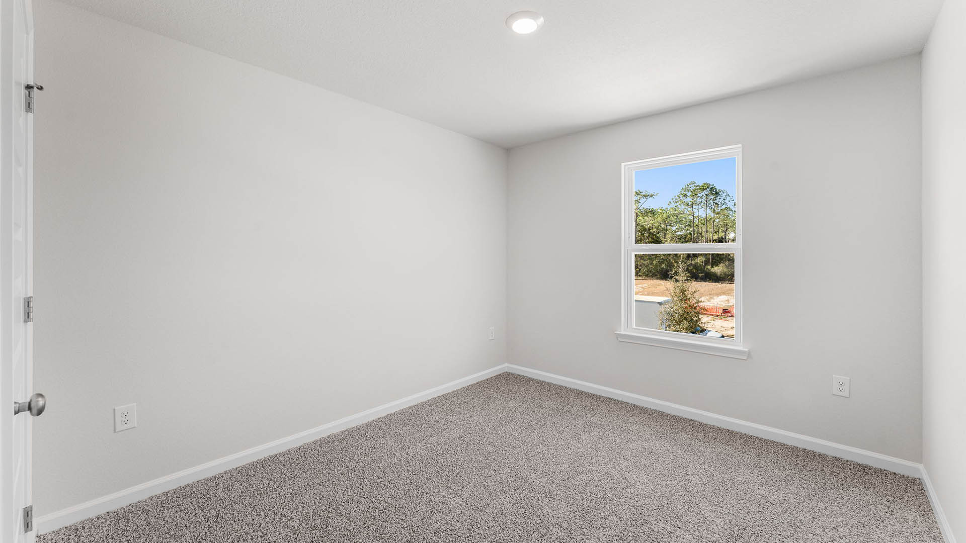 Bedroom with carpet floor and window.