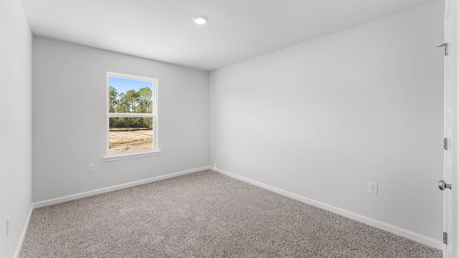 Bedroom with carpet floor and window.