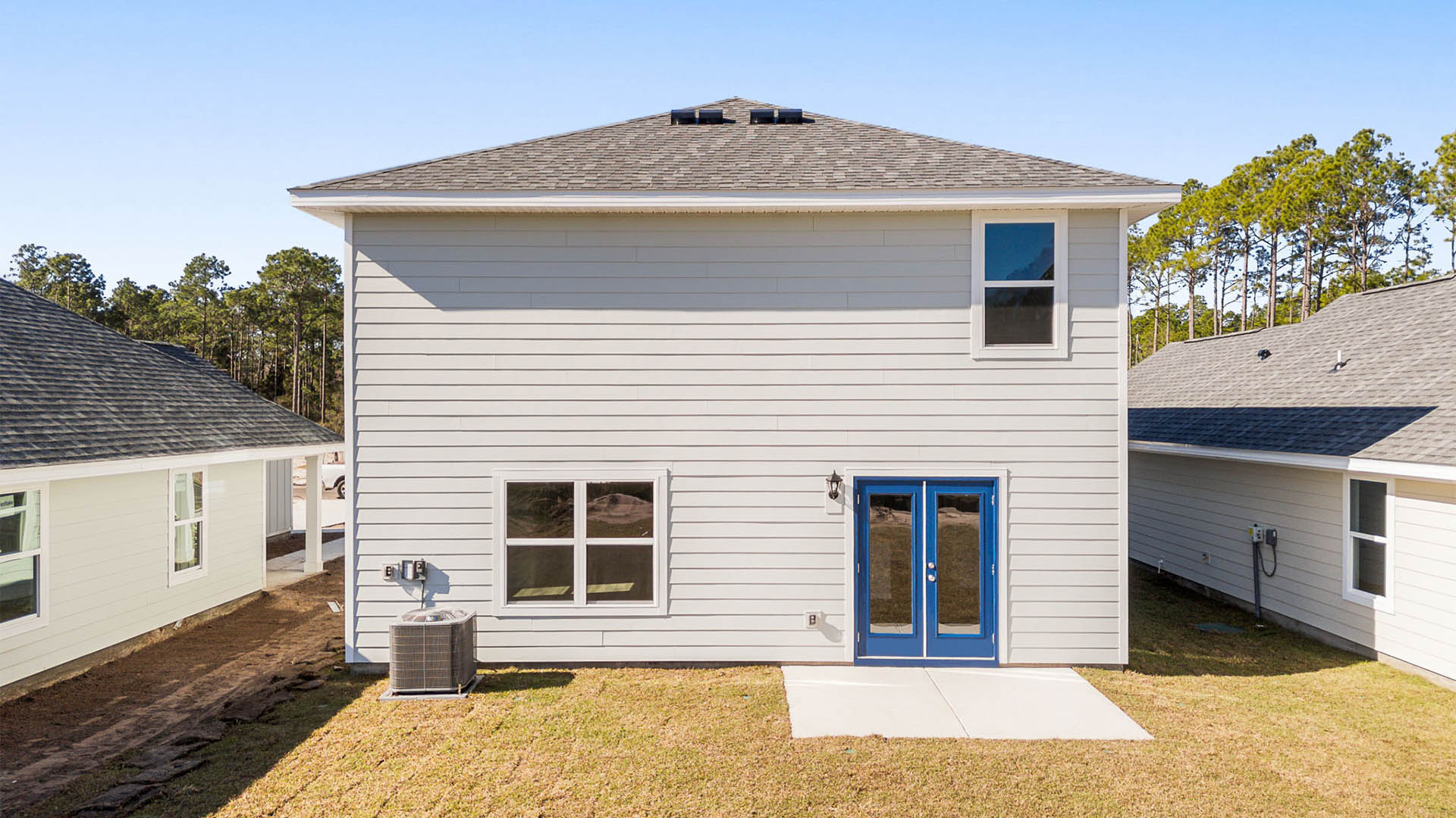 Aisle plan rear of home with Hardie siding and concrete pad.
