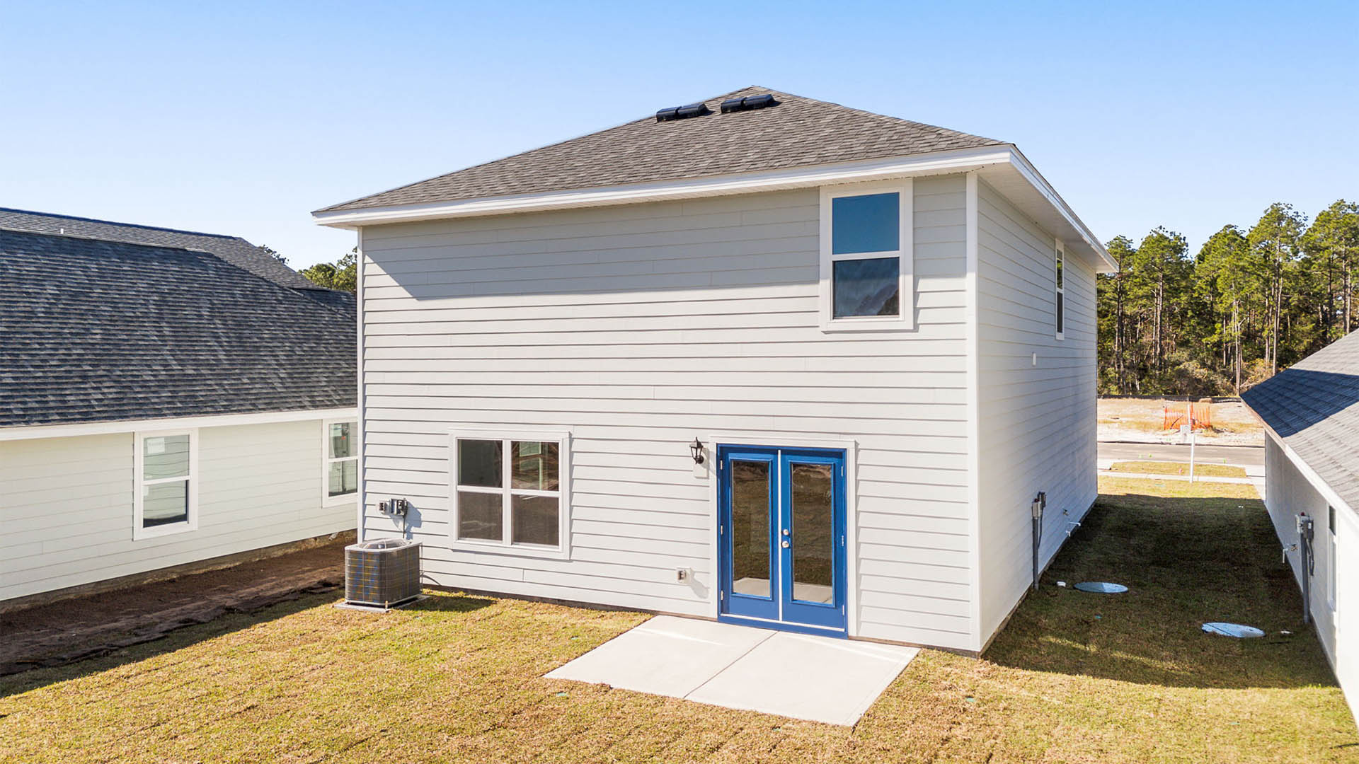 Aisle plan rear of home with Hardie siding and concrete pad.