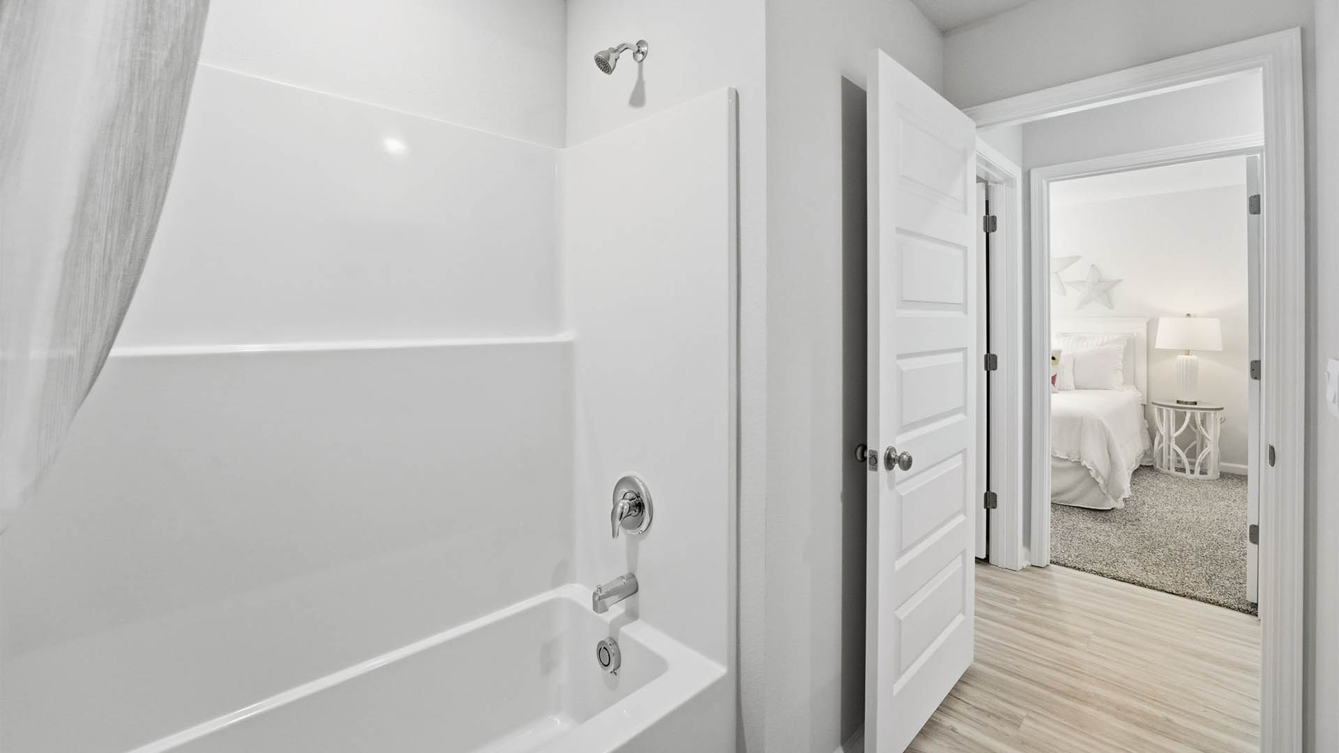Bathroom with EVP flooring and shower tub combo.