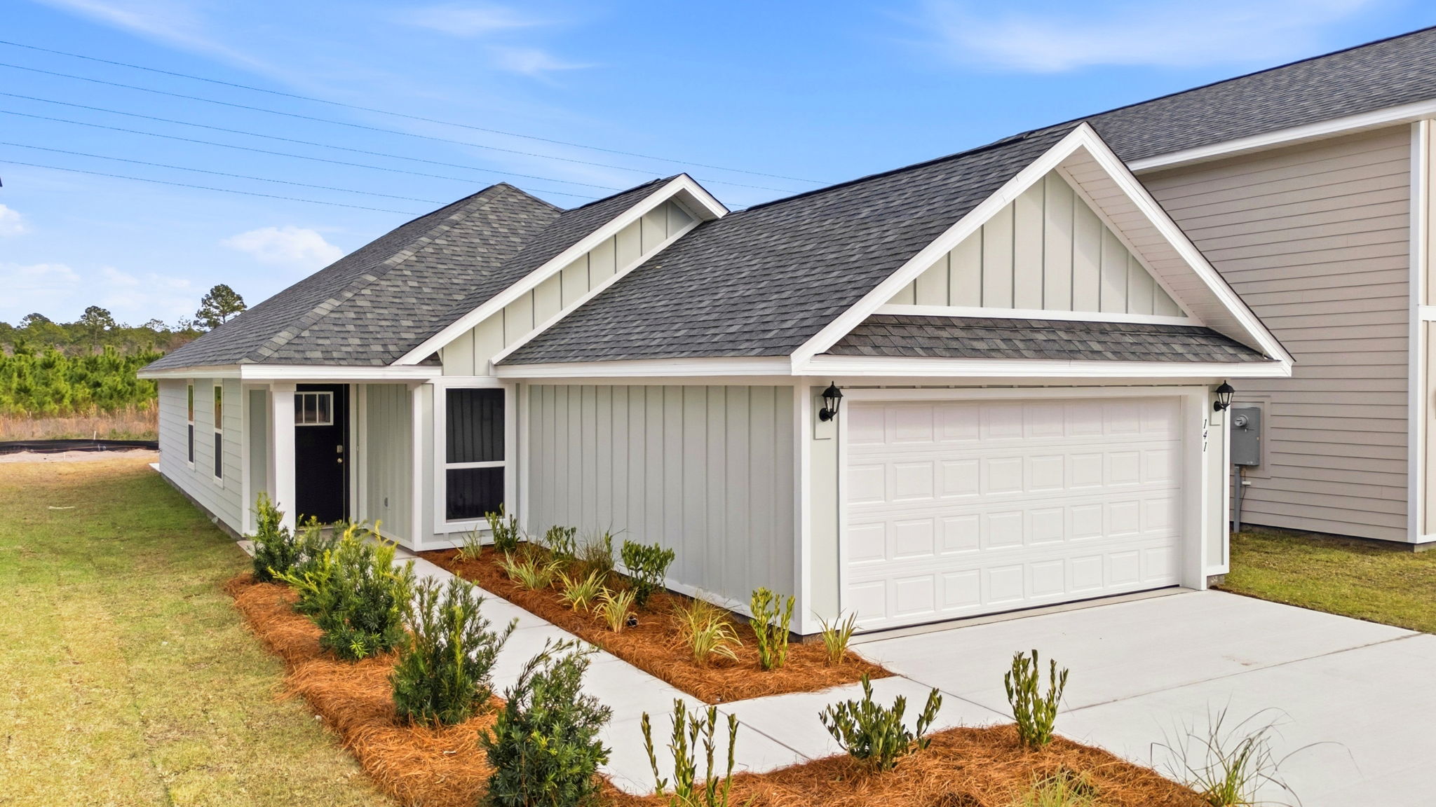 Celeste plan front of home with Hardie siding and two car garage.