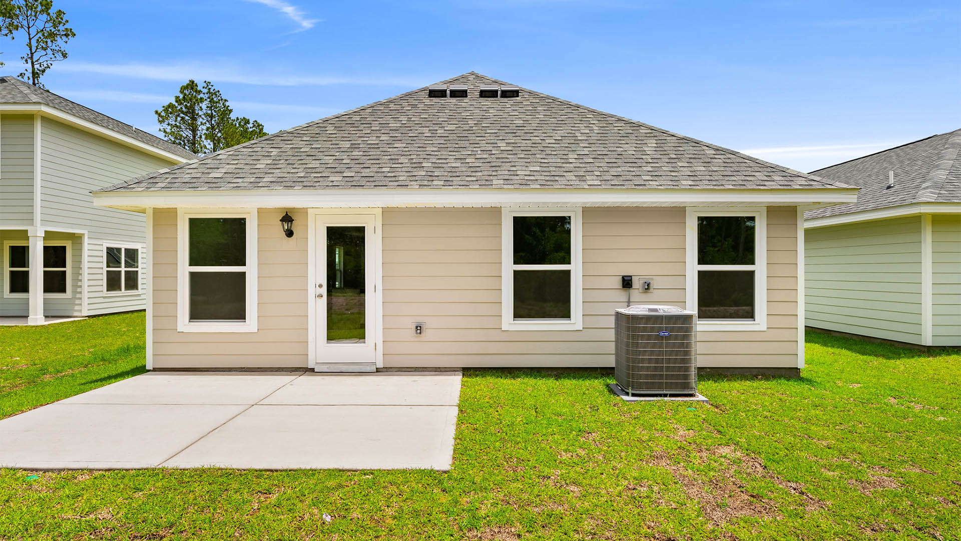 Celeste Plan rear of home with Hardie siding and concrete patio and back yard.