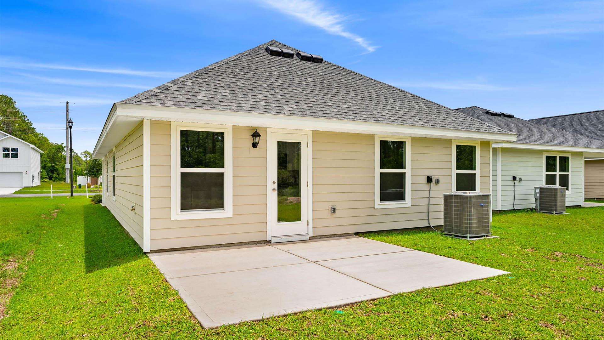 Celeste Plan rear of home with Hardie siding and concrete patio and back yard.