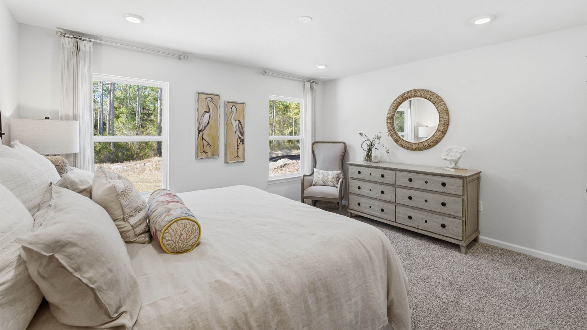 Primary bedroom with carpet floors and windows.