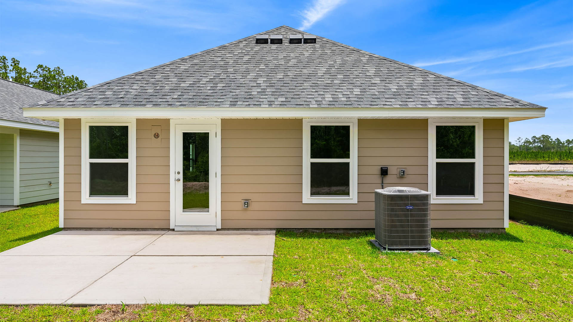 Celeste Plan rear of home with Hardie siding and concrete patio and back yard.
