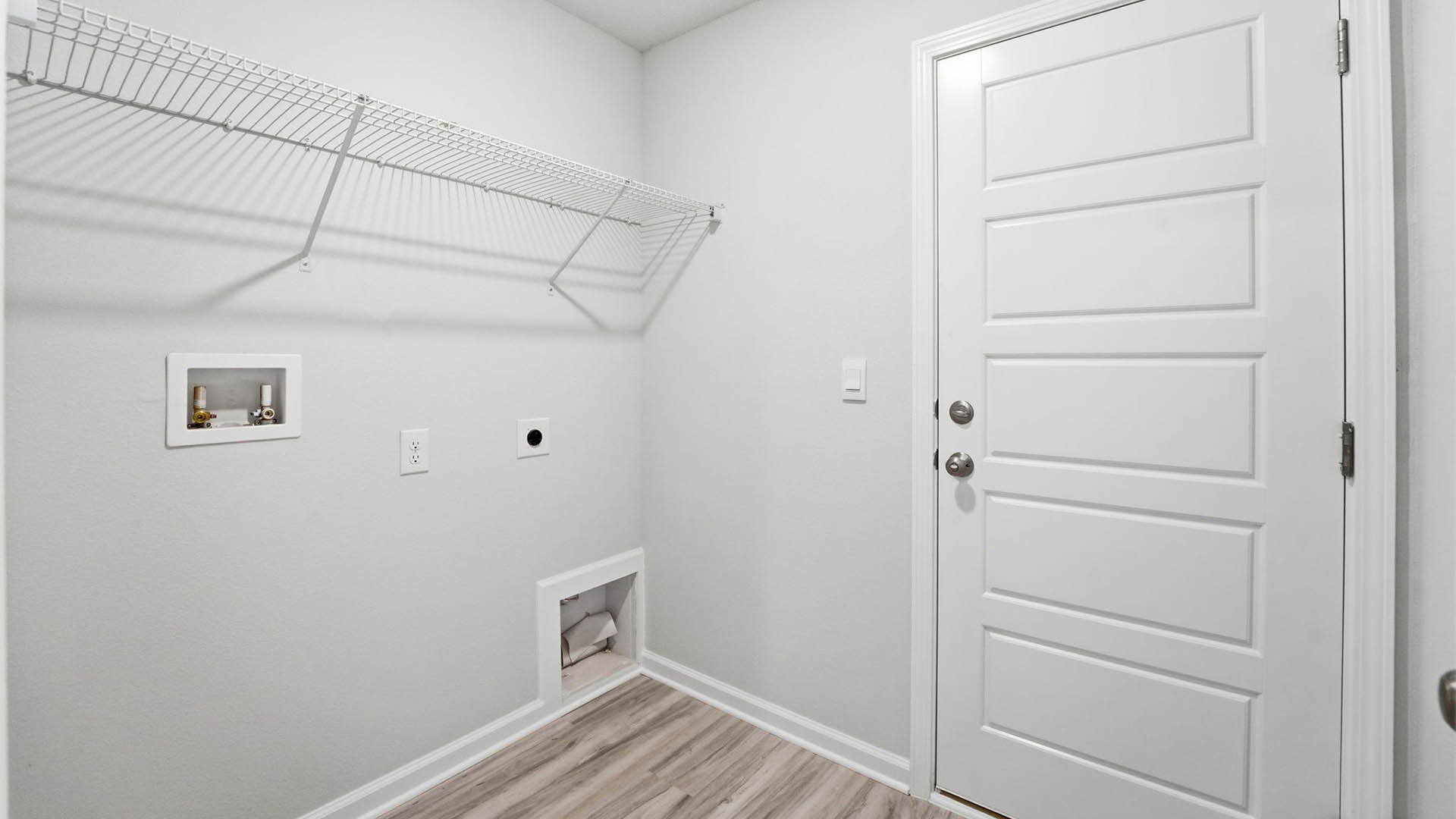 Laundry room with ventilated shelving.