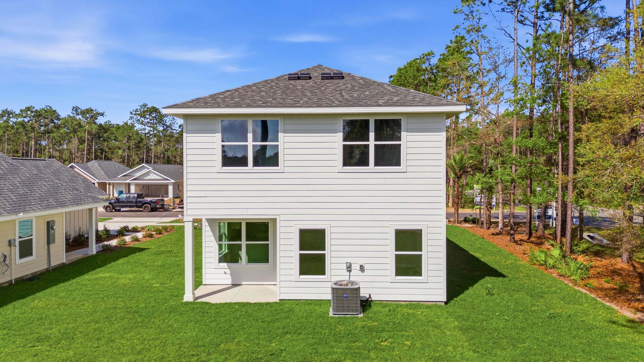 Monroe plan rear of home with covered rear patio and back yard.