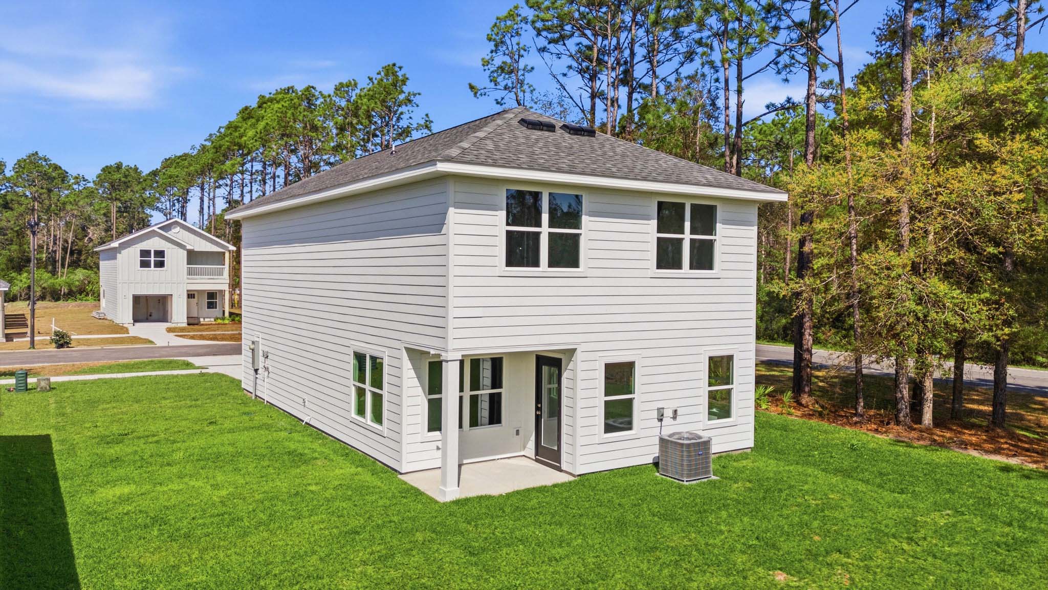 Monroe plan rear of home with covered rear patio and back yard.