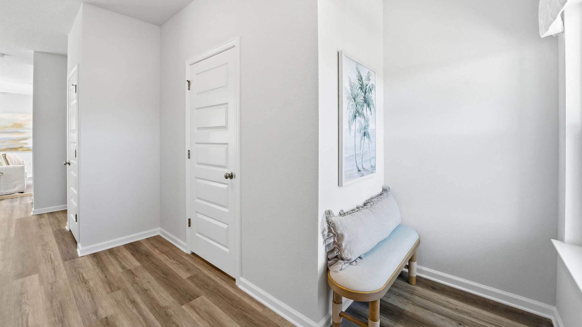 Front entrance with EVP flooring next to half-bathroom and closet.