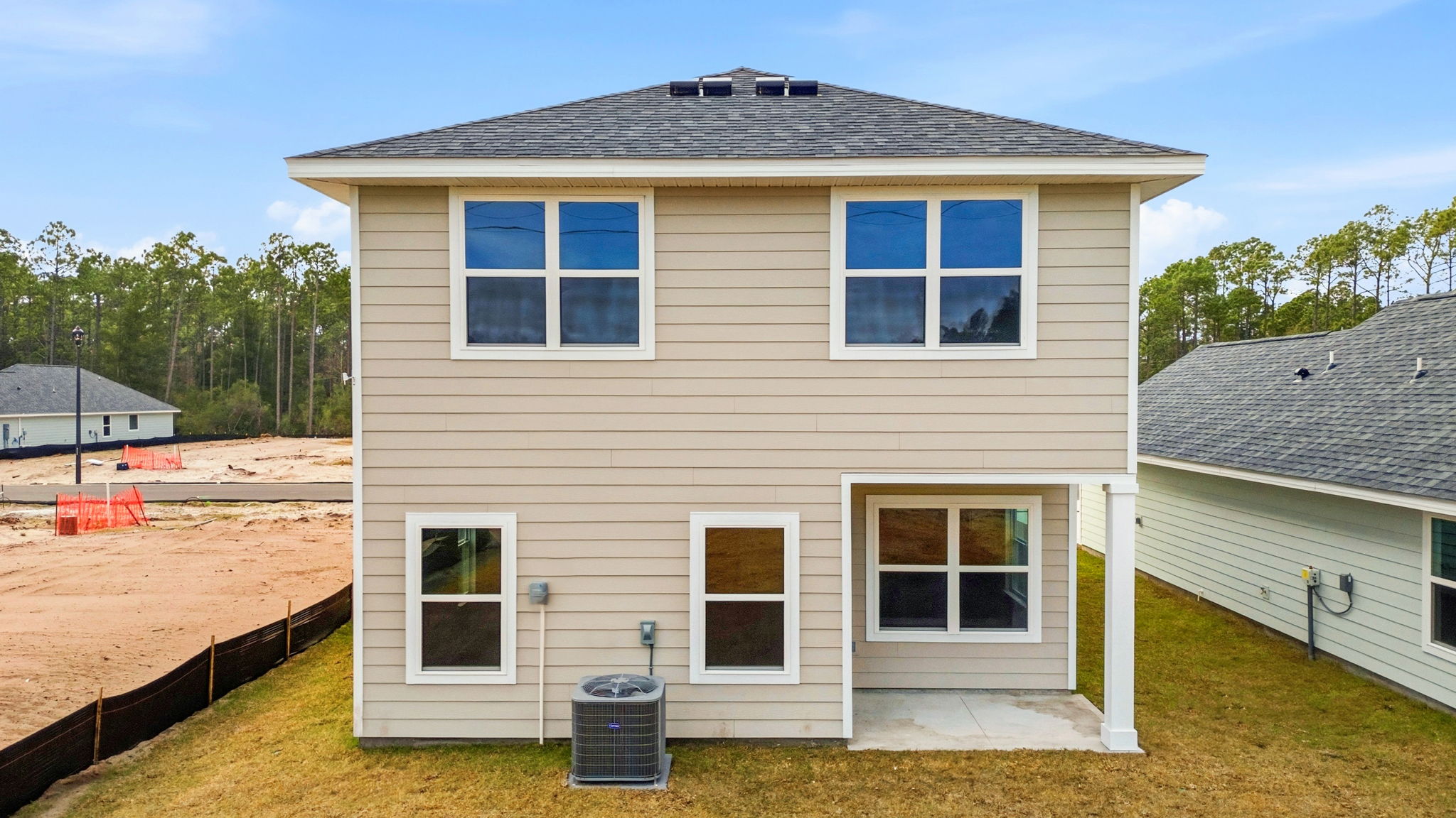 Monroe plan rear of home with covered rear patio and back yard.