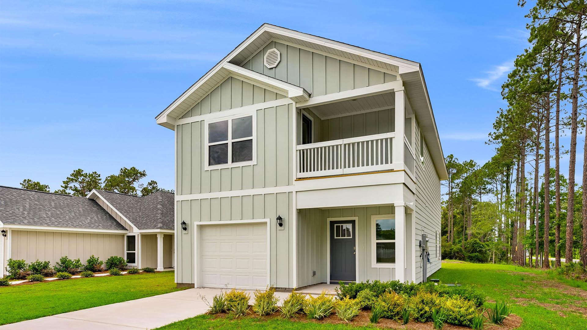 Monroe plan with Hardie siding and single-car garage and second floor balcony and covered front patio.