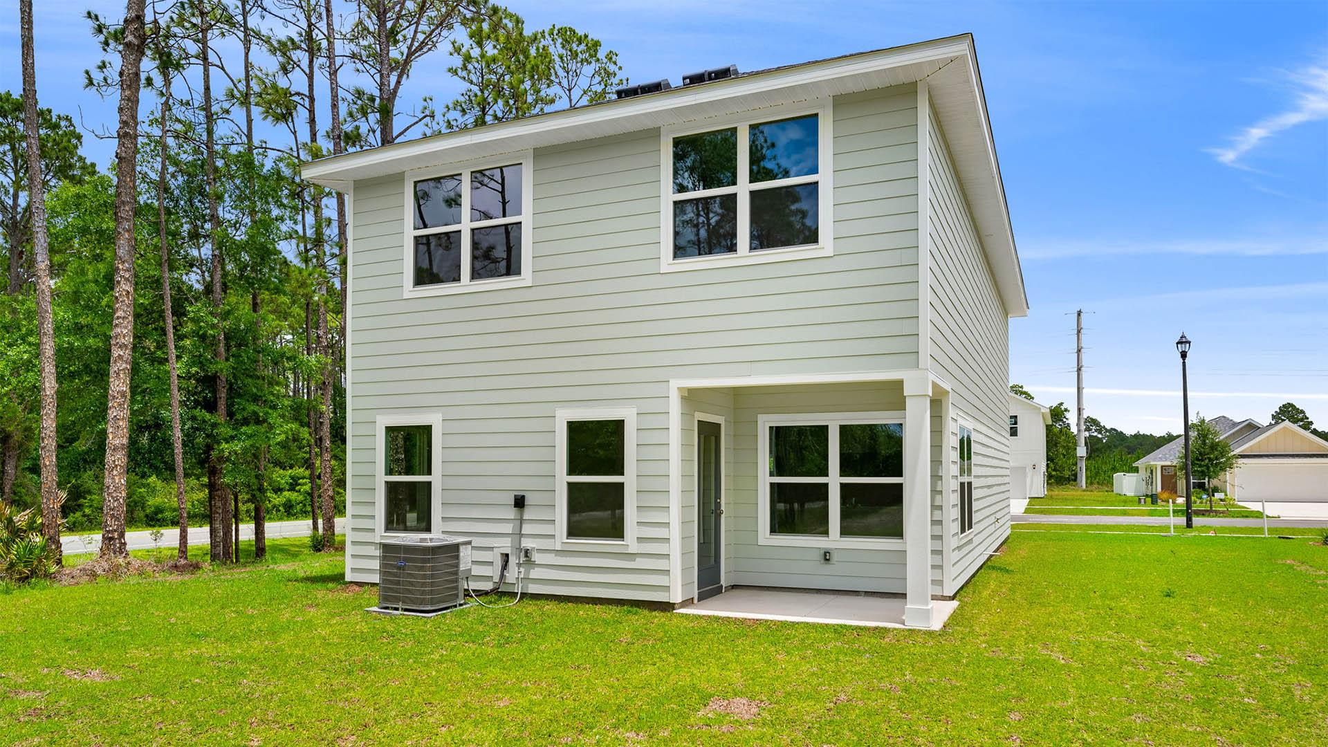 Monroe plan rear of home with covered rear patio and back yard.