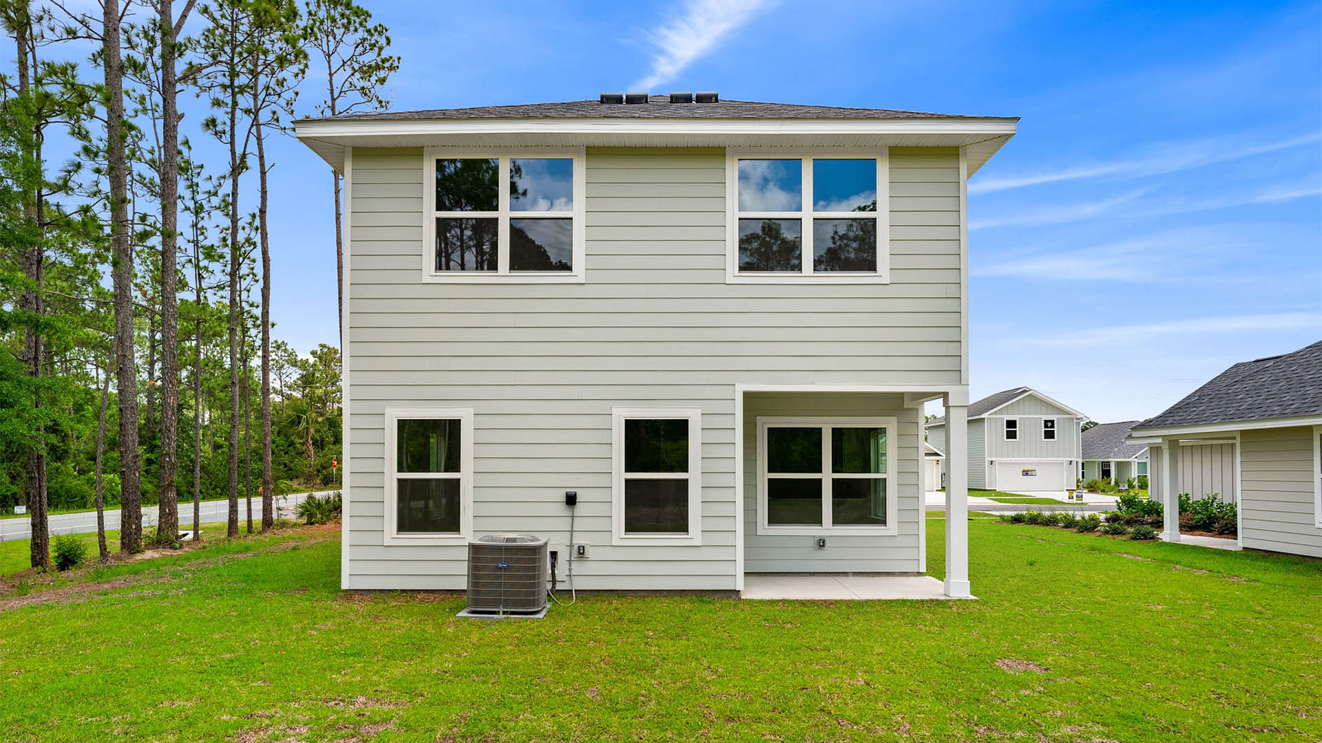 Monroe plan rear of home with covered rear patio and back yard.
