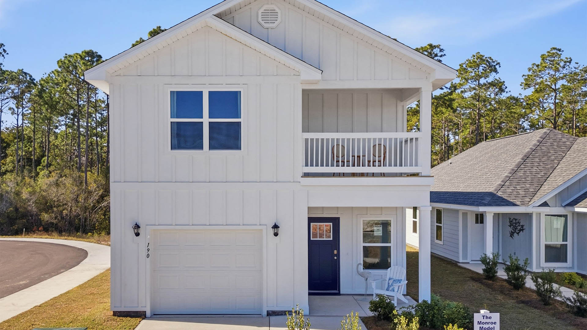 Monroe plan with Hardie siding and single-car garage and second floor balcony and covered front patio.