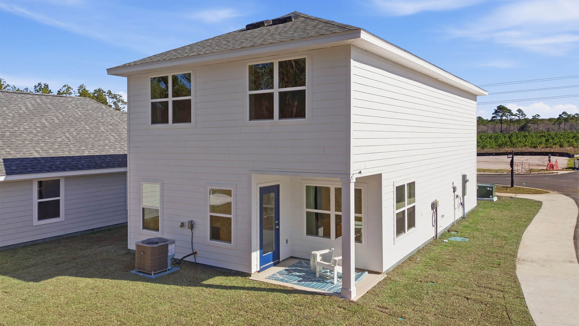 Monroe plan rear of home with covered rear patio and back yard.