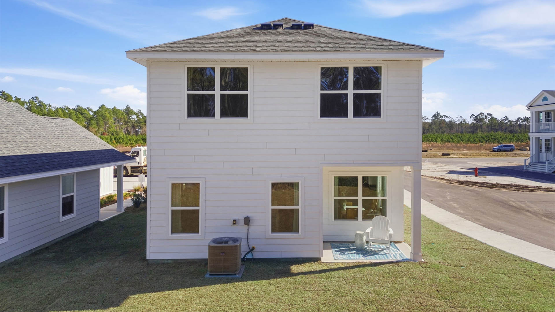 Monroe plan rear of home with covered rear patio and back yard.