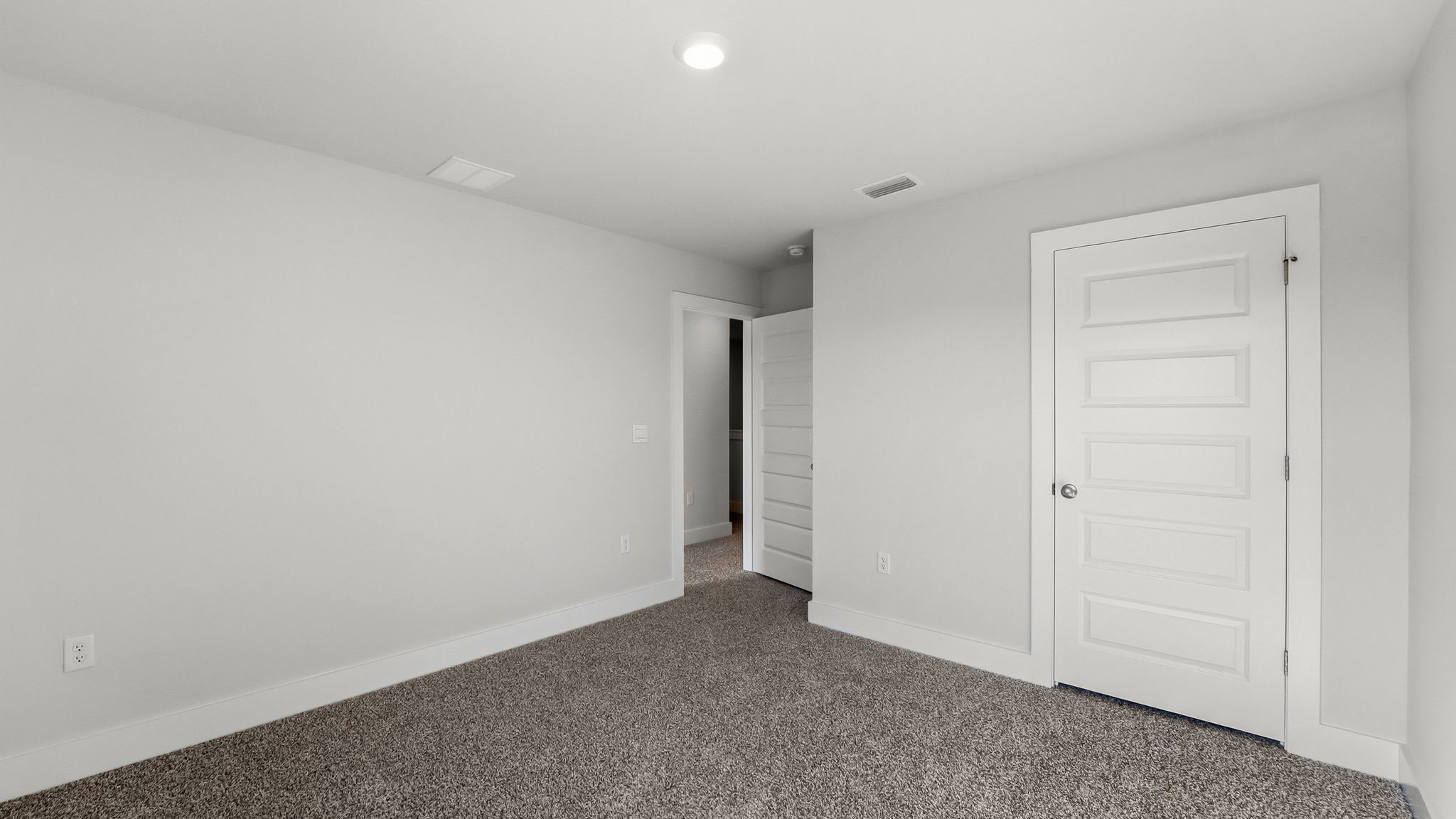 Bedroom with carpet flooring and closet.