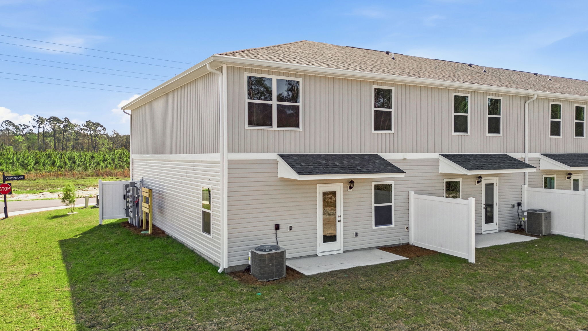 Covered back porch with air-conditioning unit.