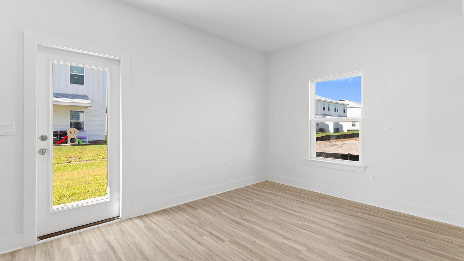 Dining room with EVP flooring and back door.