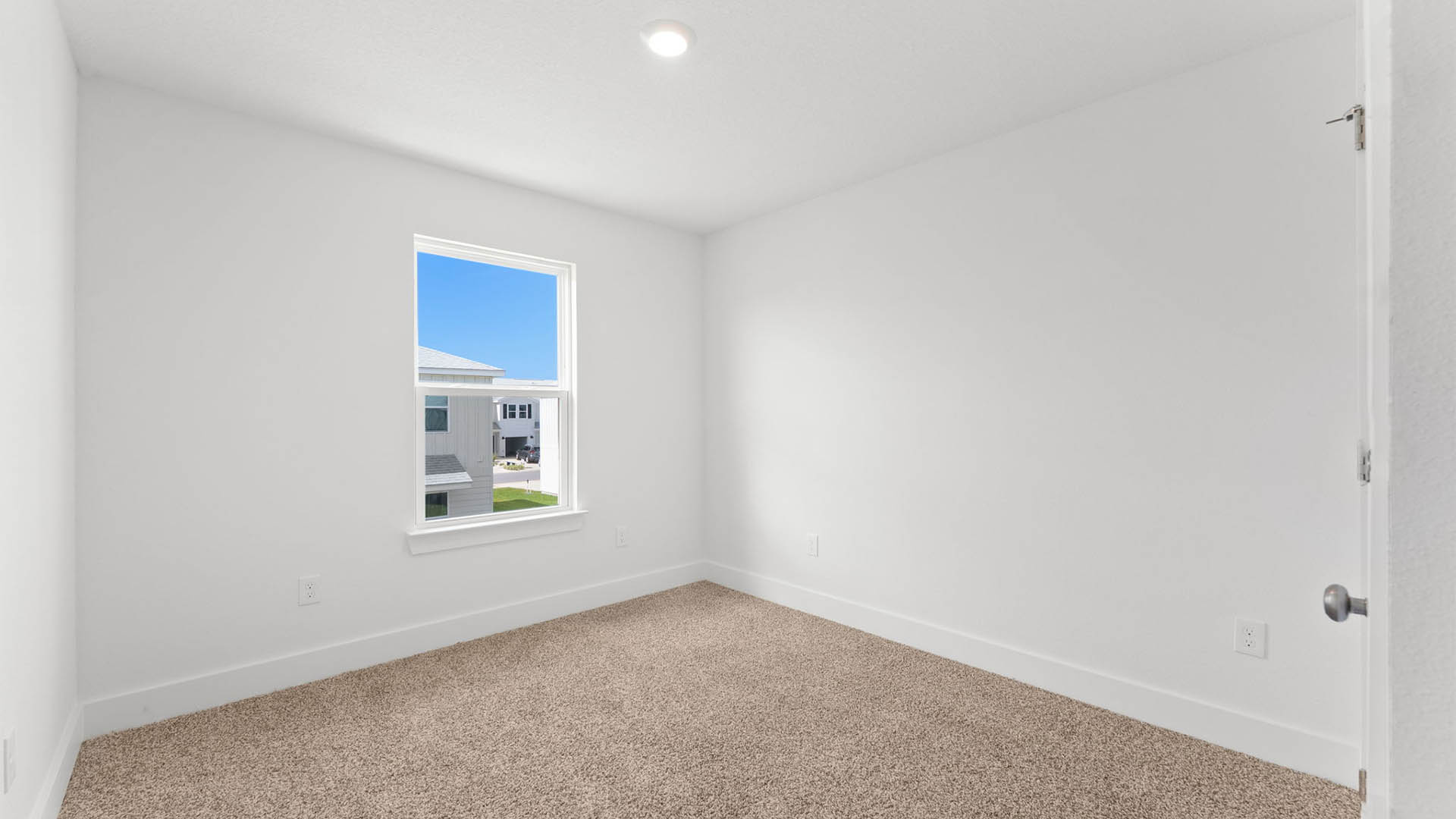 Bedroom with carpet flooring and closet and window.