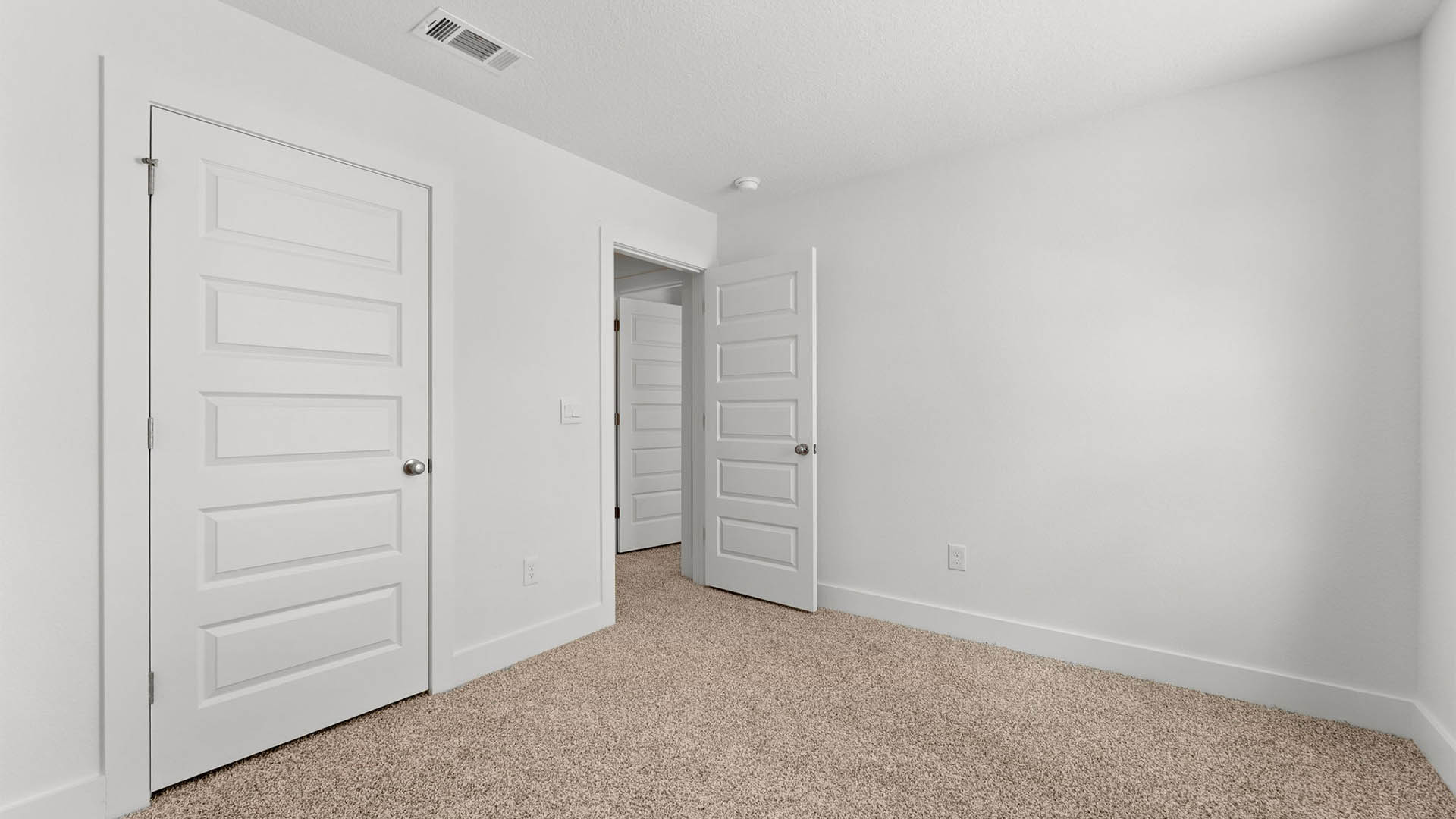 Bedroom with carpet flooring and closet.
