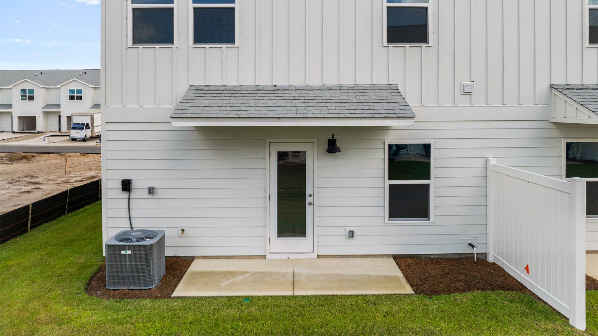 Covered back porch with air-conditioning unit.
