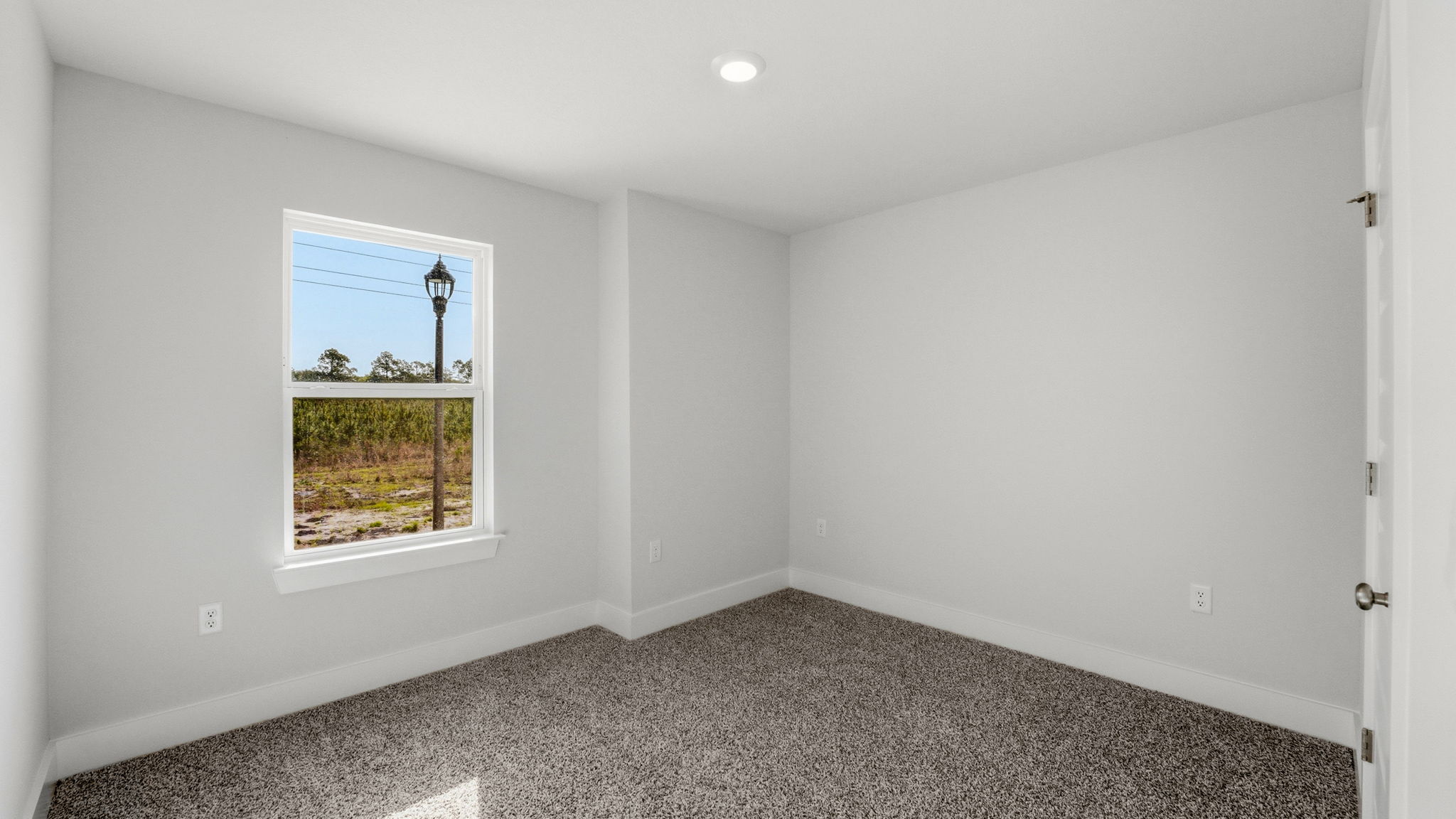 Bedroom with carpet flooring and closet and window.
