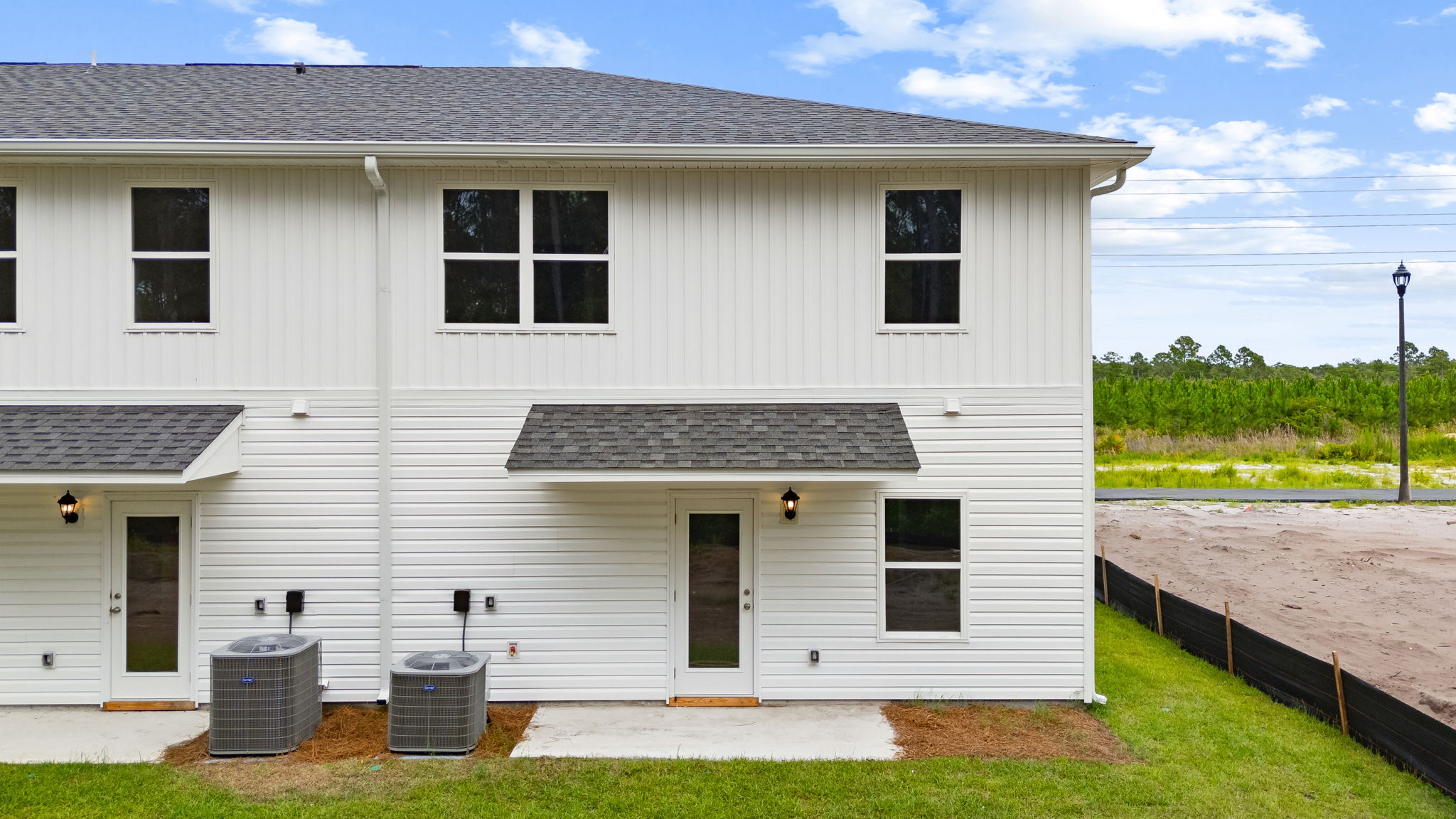 Covered back porch with air-conditioning unit.