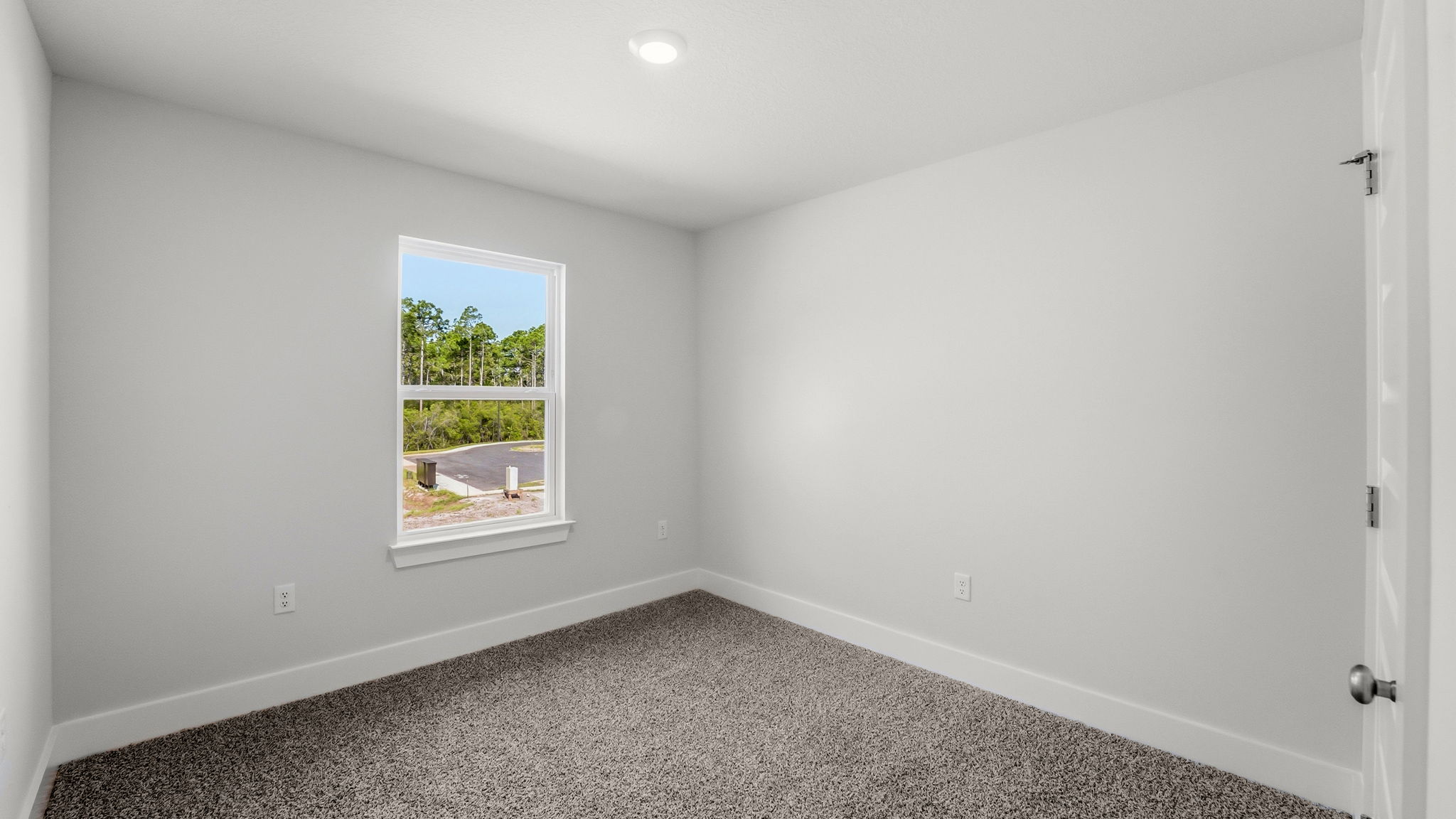 Bedroom with carpet flooring and closet and window.