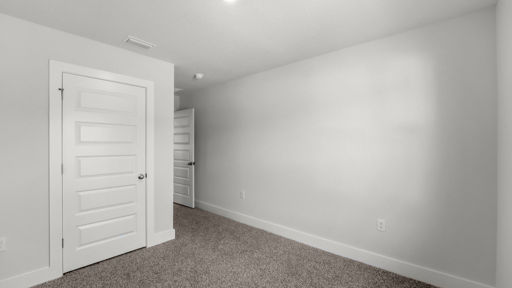 Bedroom with carpet flooring and closet.