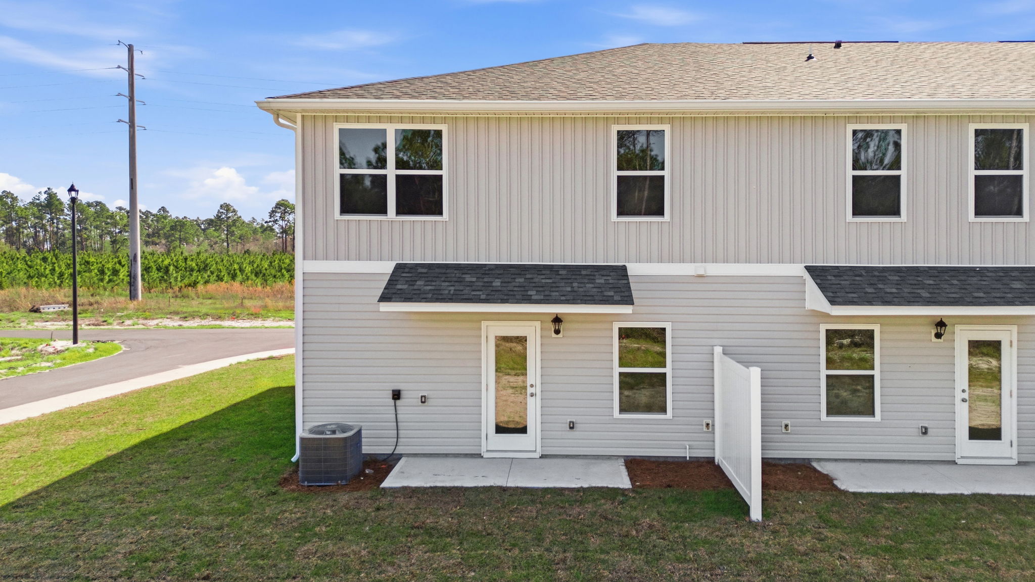 Covered back porch with air-conditioning unit.