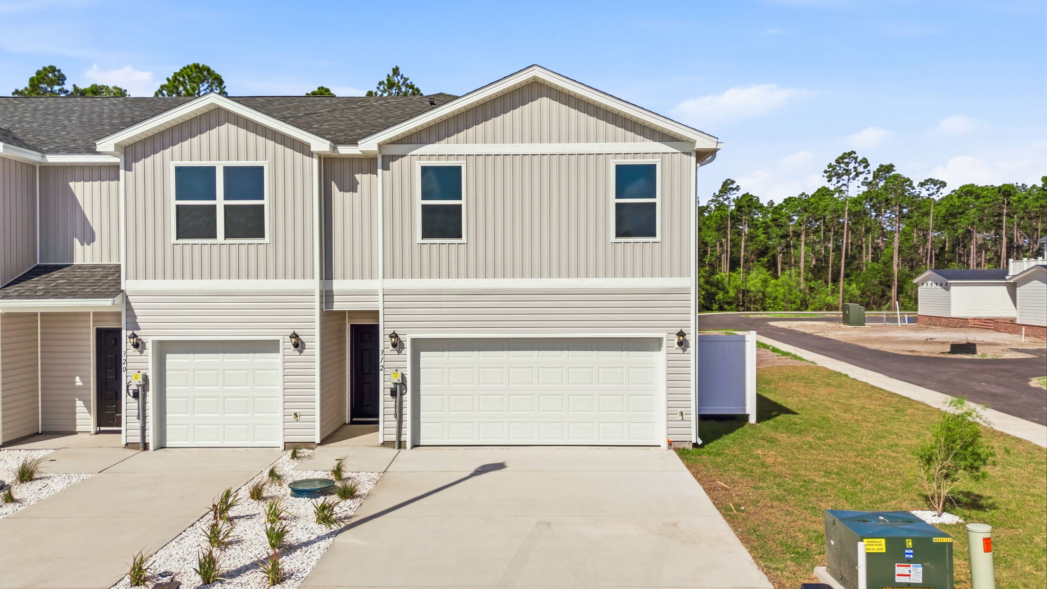 Two-story Sabal townhome with 2-car garage and vinyl siding.