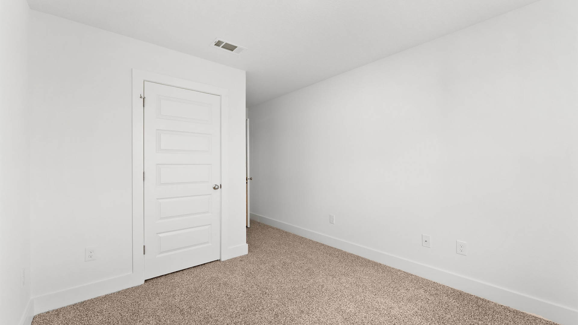 Bedroom with carpet flooring and closet.