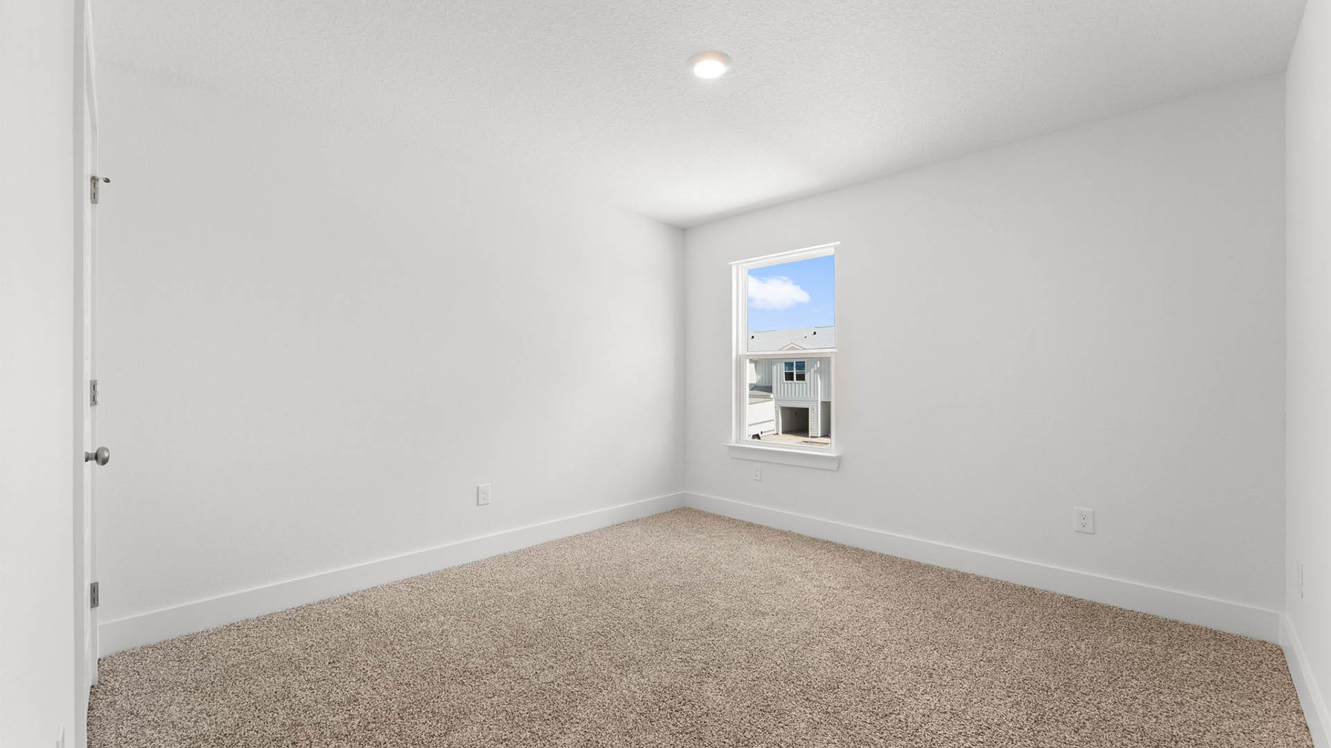 Bedroom with carpet flooring and closet and window.