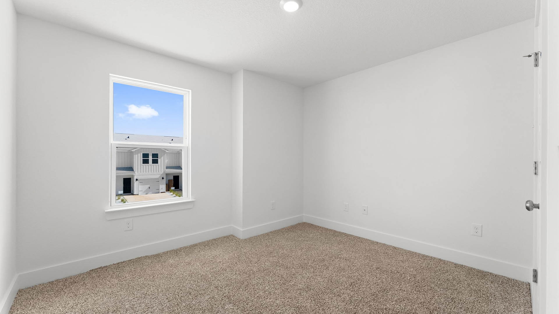 Bedroom with carpet flooring and closet and window.