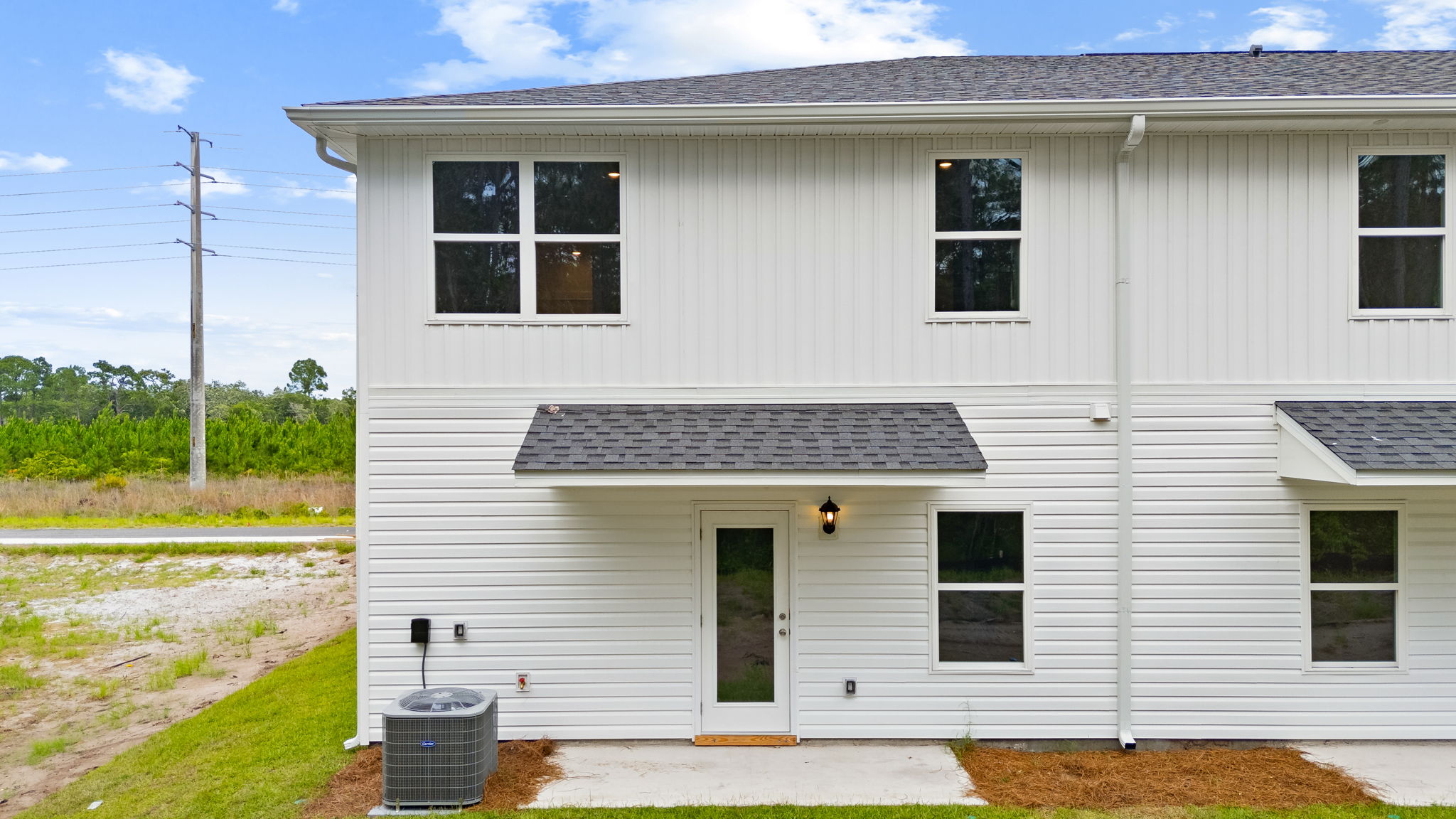 Covered back porch with air-conditioning unit.
