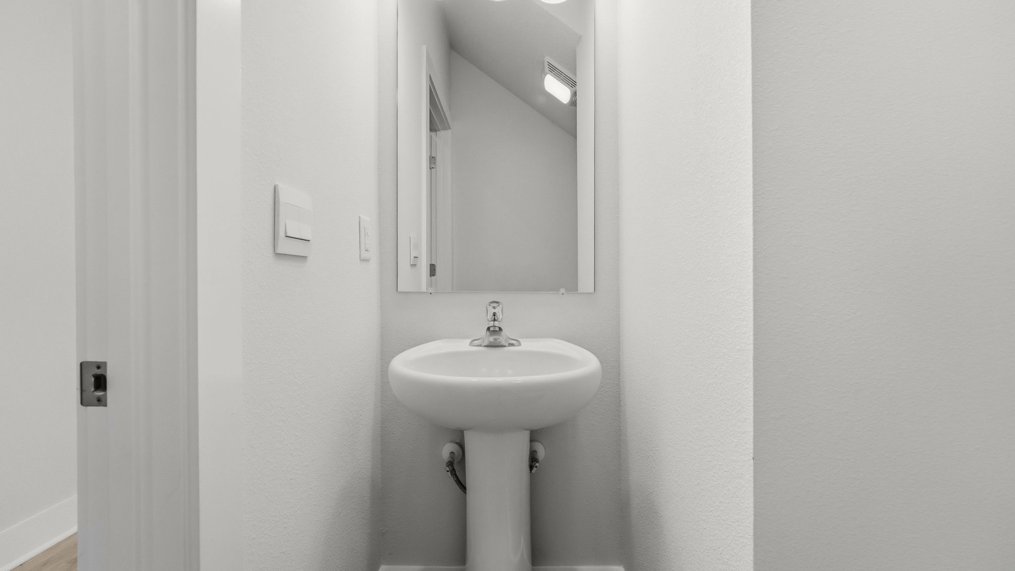 Front hallway with half bathroom.