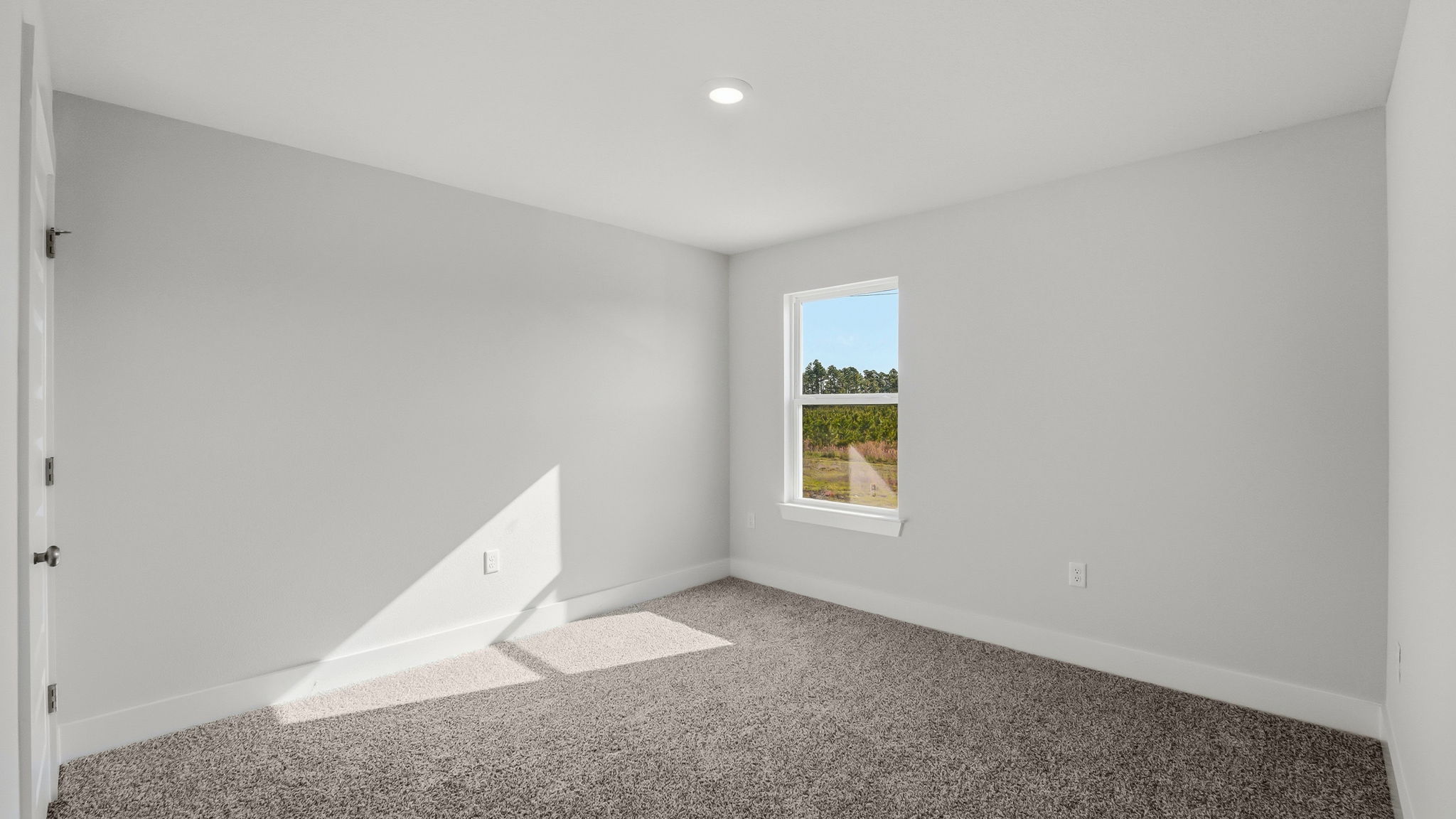 Bedroom with carpet flooring and closet and window.