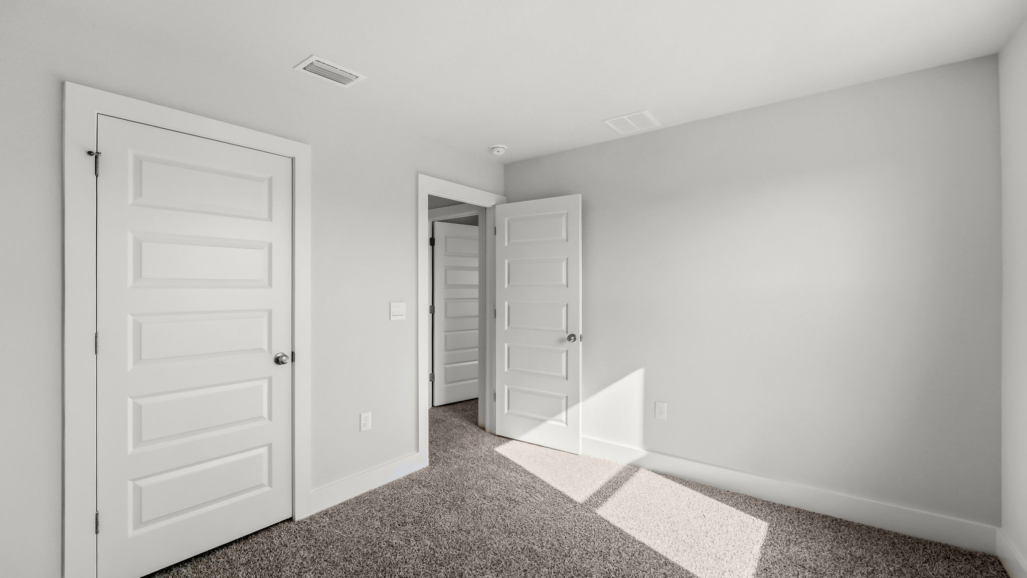 Bedroom with carpet flooring and closet.