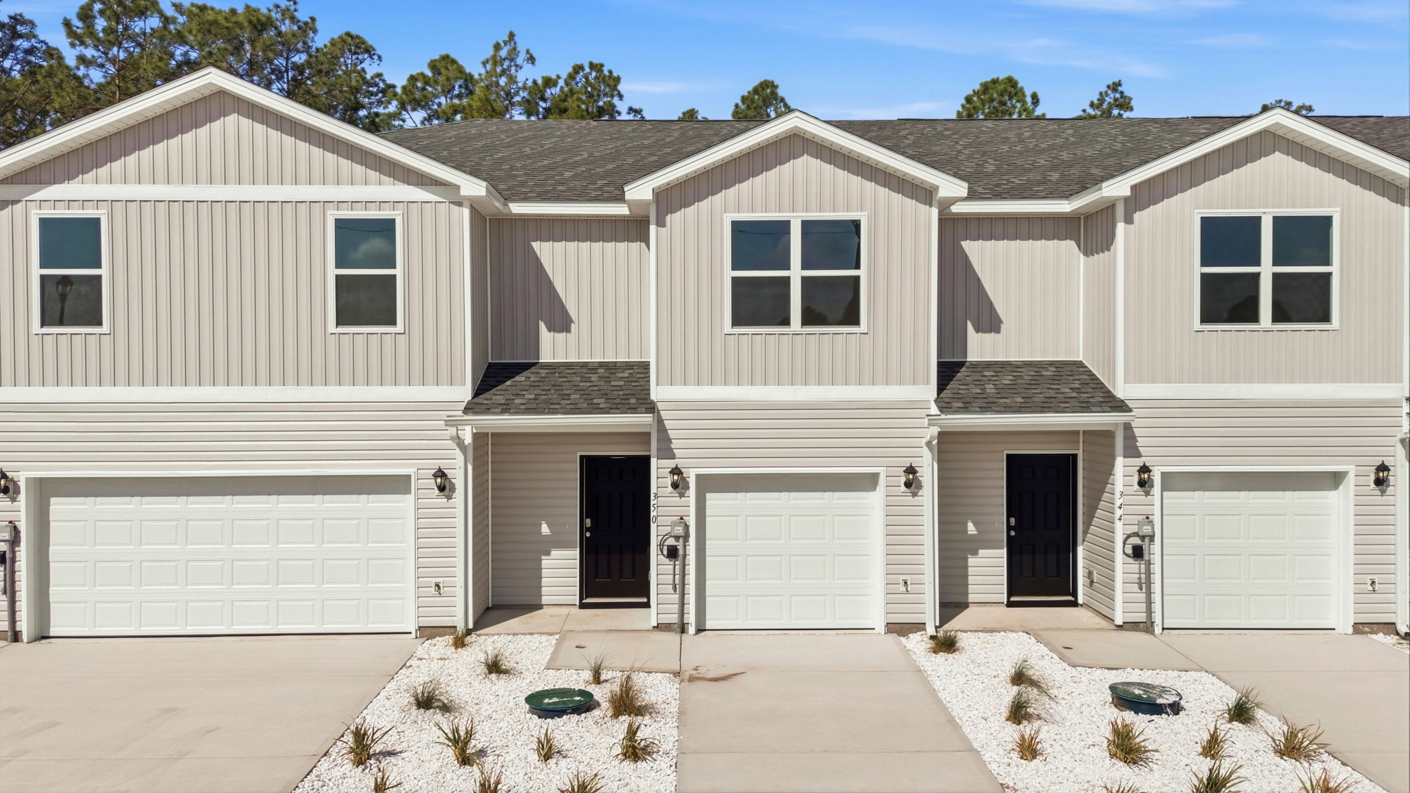 Two-story Sabal townhome with 2-car garage and vinyl siding.