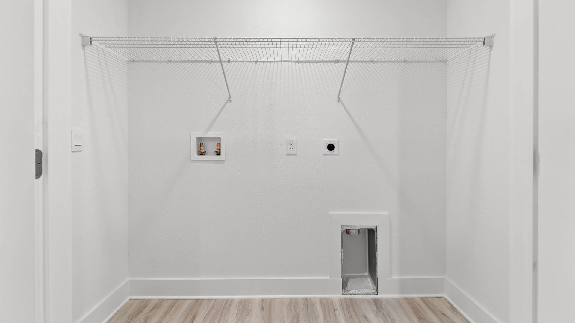 Laundry room with EVP flooring and ventilated shelving.