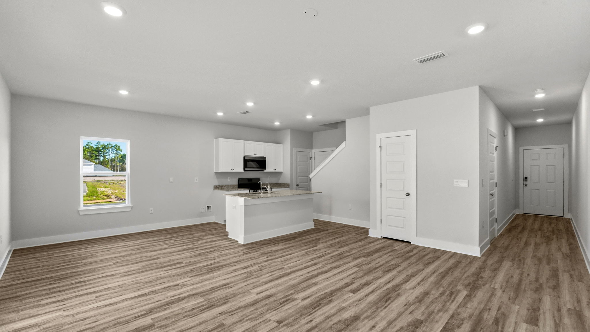 Open living room and kitchen with island.