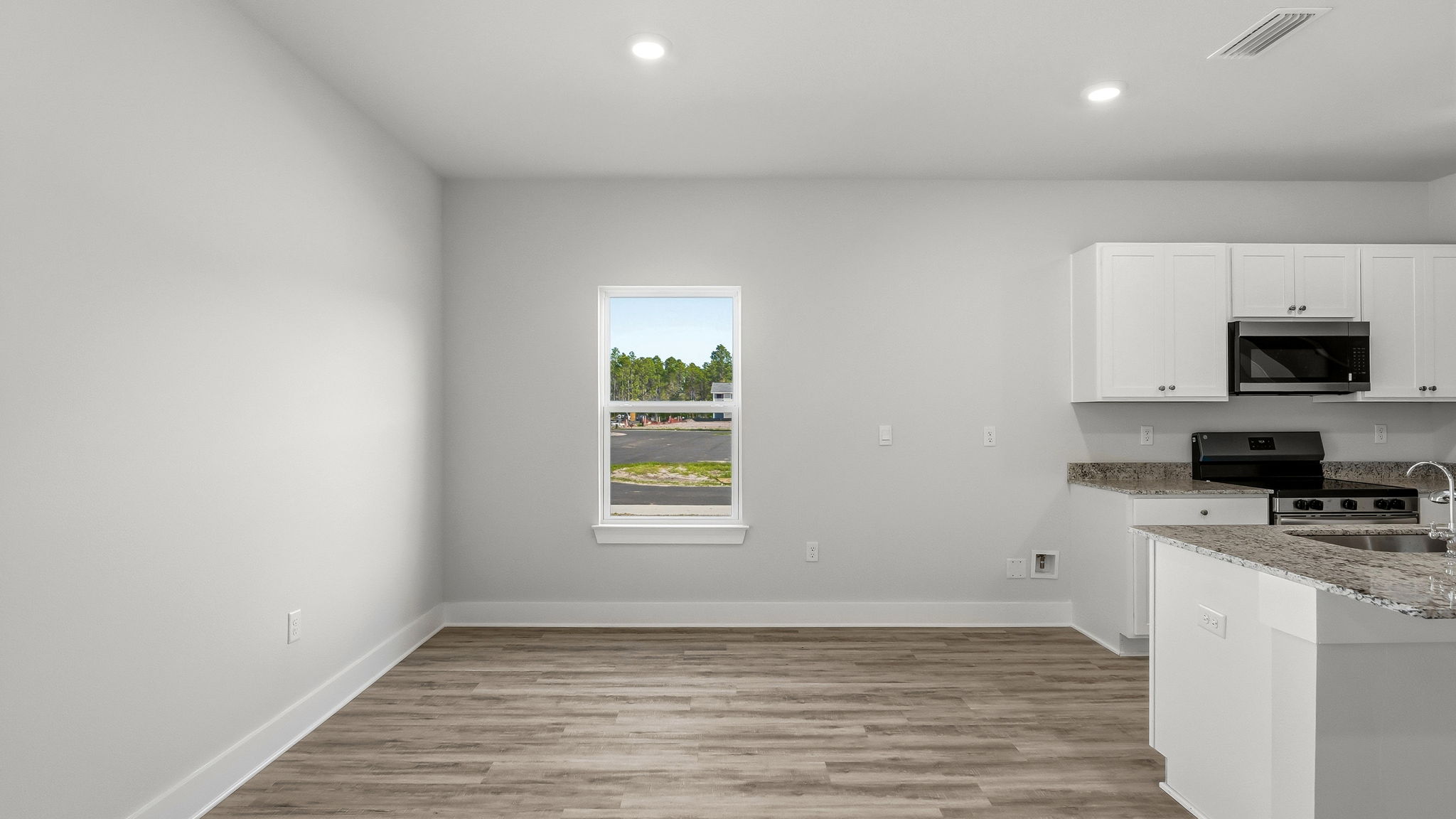 Dining area next to kitchen with window.