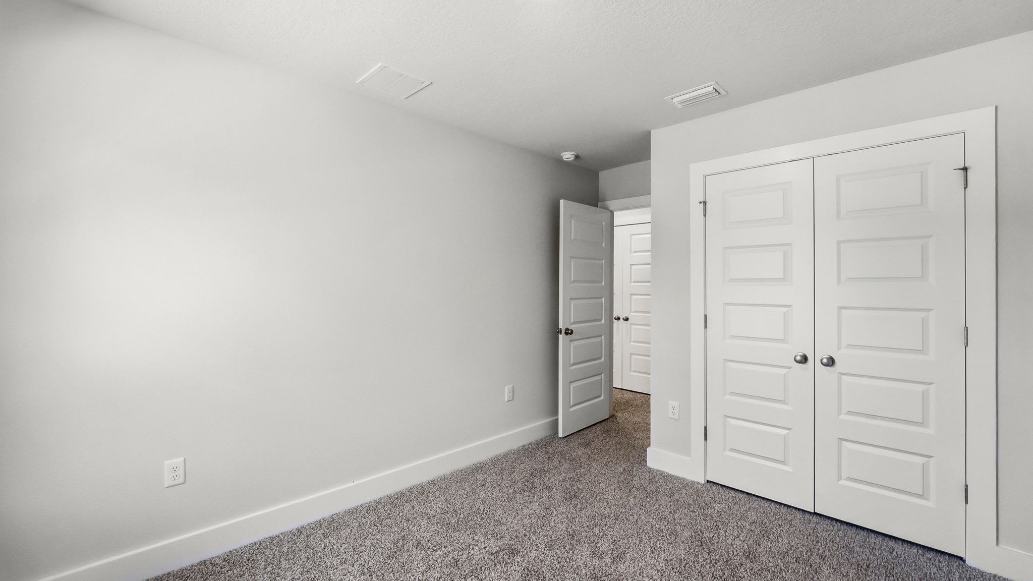 Bedroom with carpet flooring and closet.