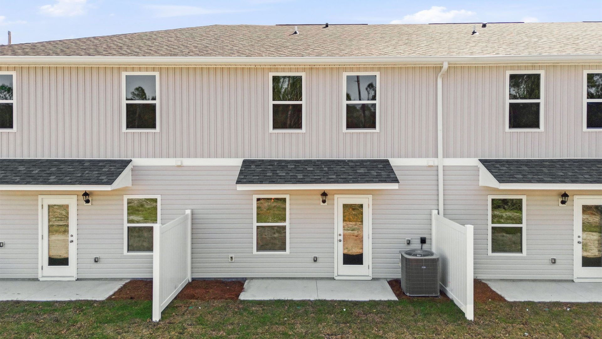 Covered back porch with air-conditioning unit.