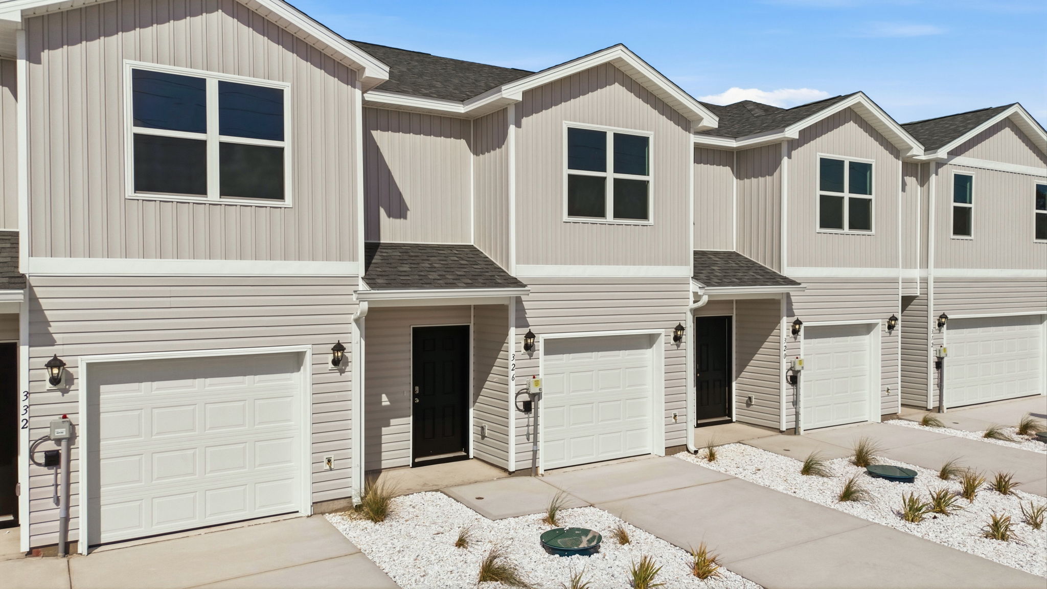 Sabal townhome with single car garage and vinyl siding.
