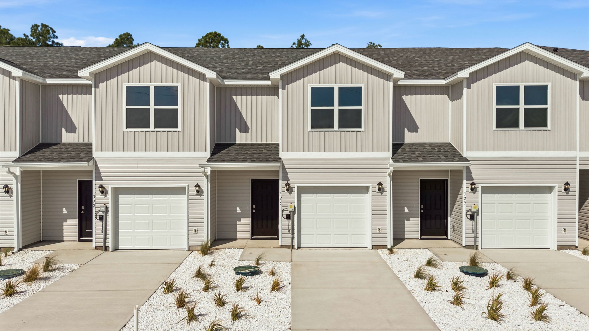 Sabal townhome with single car garage and vinyl siding.
